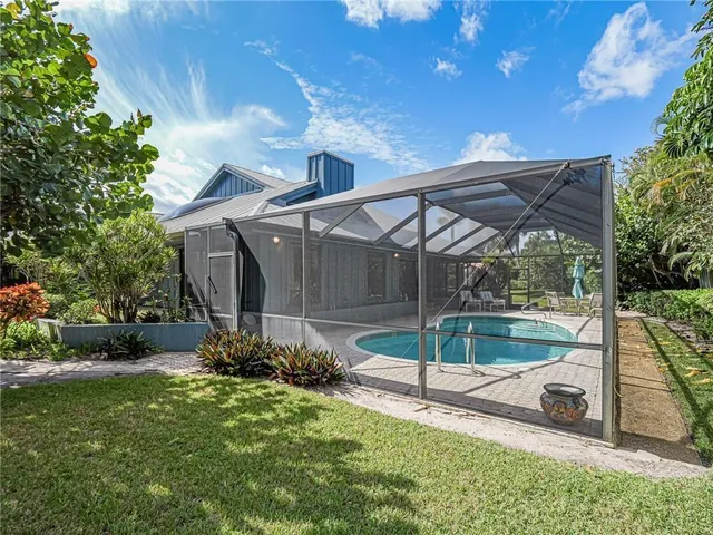 an aerial view of house with yard swimming pool and outdoor seating