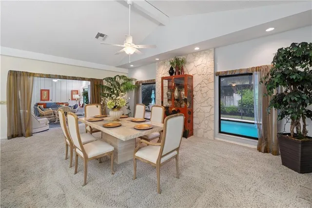 a view of a dining room with furniture and chandelier