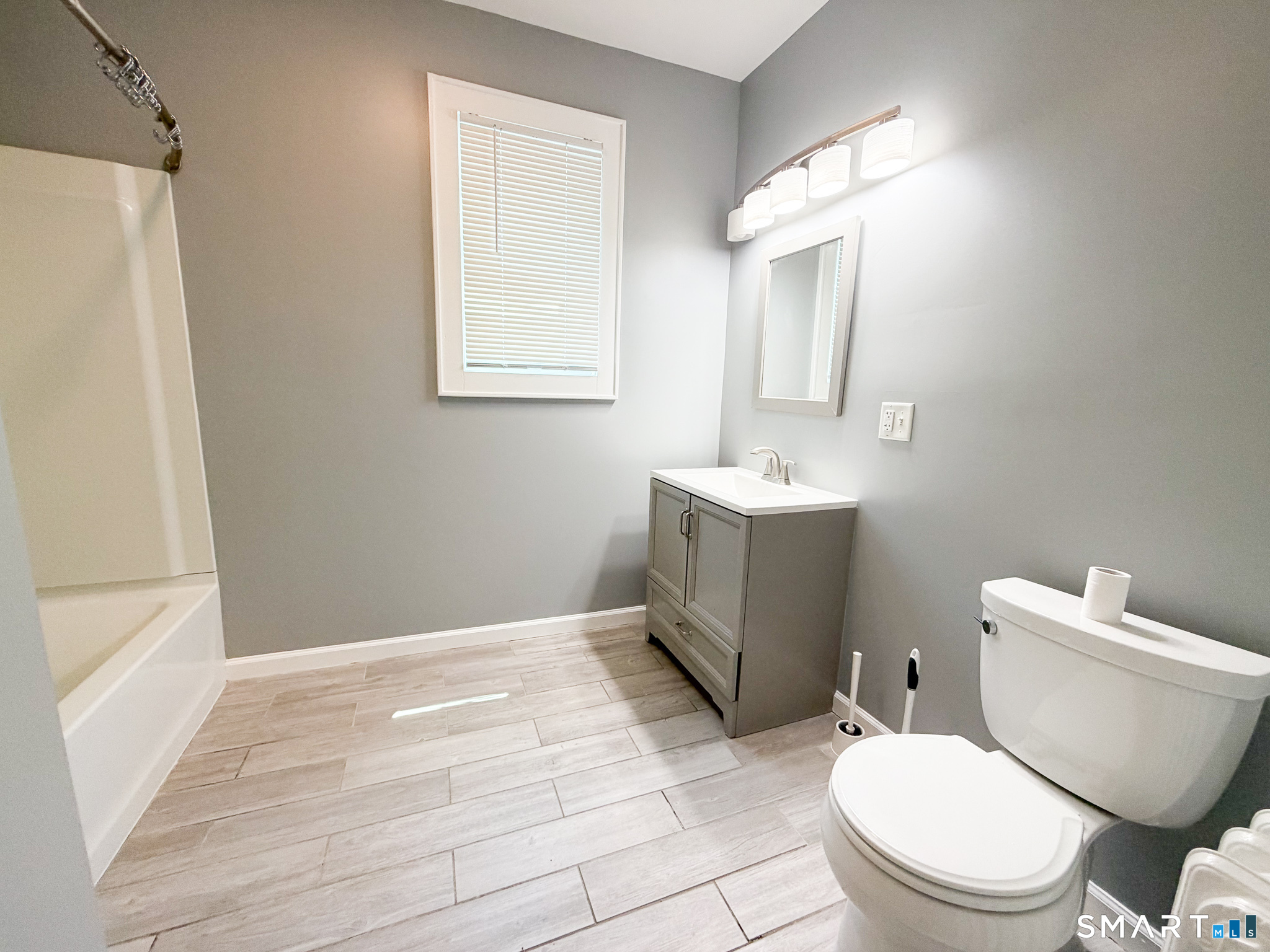 793 Milford Point Road, Unit 1 Milford, CT 06460 - Photo 13 of 16 a white toilet sitting next to a bathroom sink