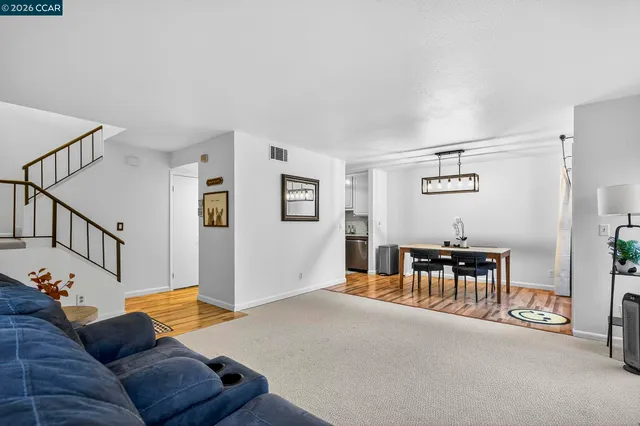 a living room with furniture and a dining table