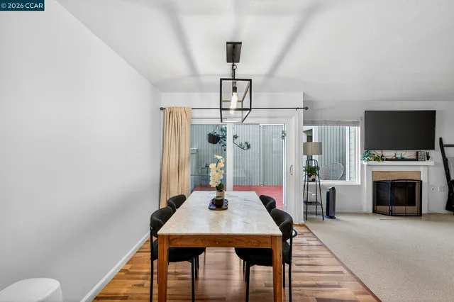 a view of a dining room with furniture window and wooden floor
