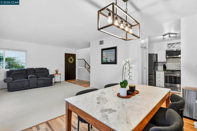 a view of a dining room with furniture and wooden floor