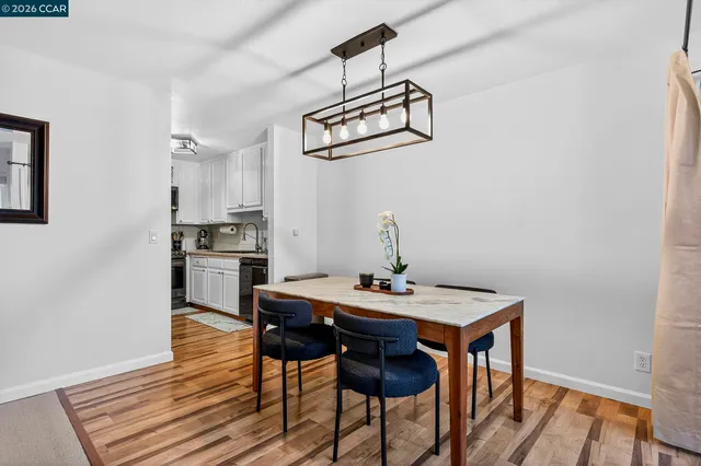 a kitchen with granite countertop a sink stove and refrigerator