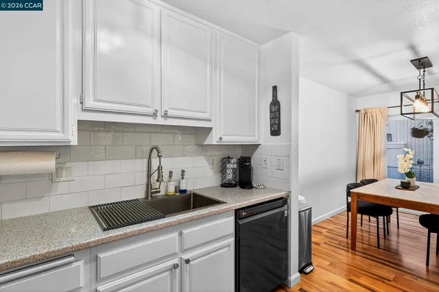a view of a livingroom with furniture and hardwood floor