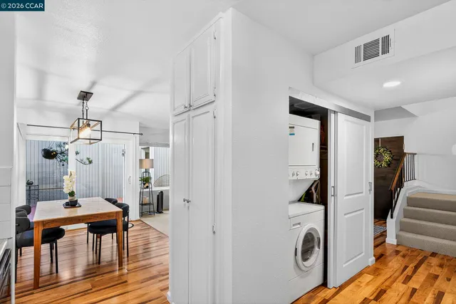 a kitchen with stainless steel appliances granite countertop white cabinets and a stove top oven