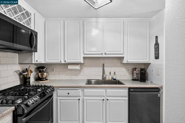 a kitchen with a stove and a refrigerator