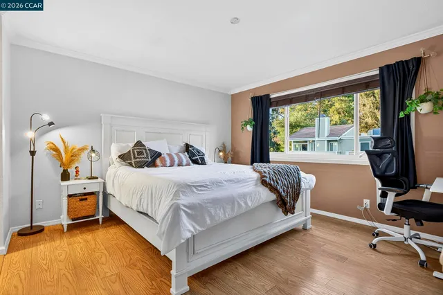 a bedroom with a bed and flat screen tv