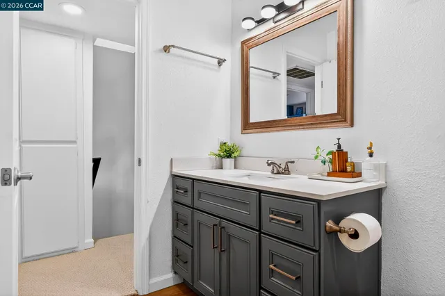 a bathroom with a sink toilet a mirror and shower