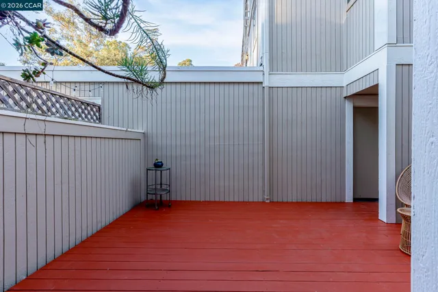 a view of swimming pool with outdoor seating and trees in the background