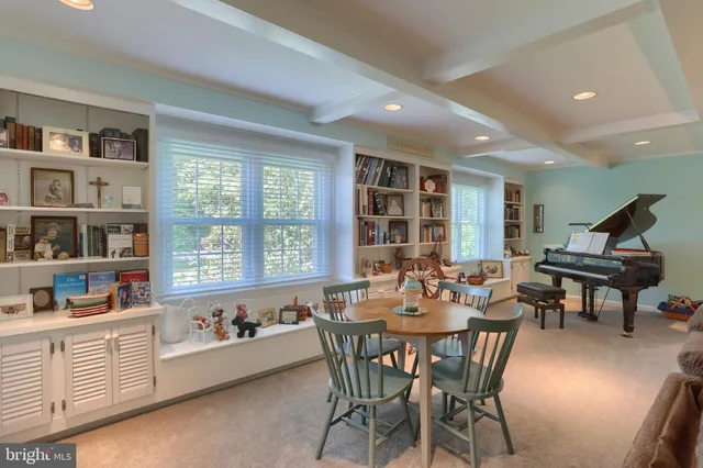 a kitchen with granite countertop a refrigerator a sink dishwasher and white cabinets with wooden floor