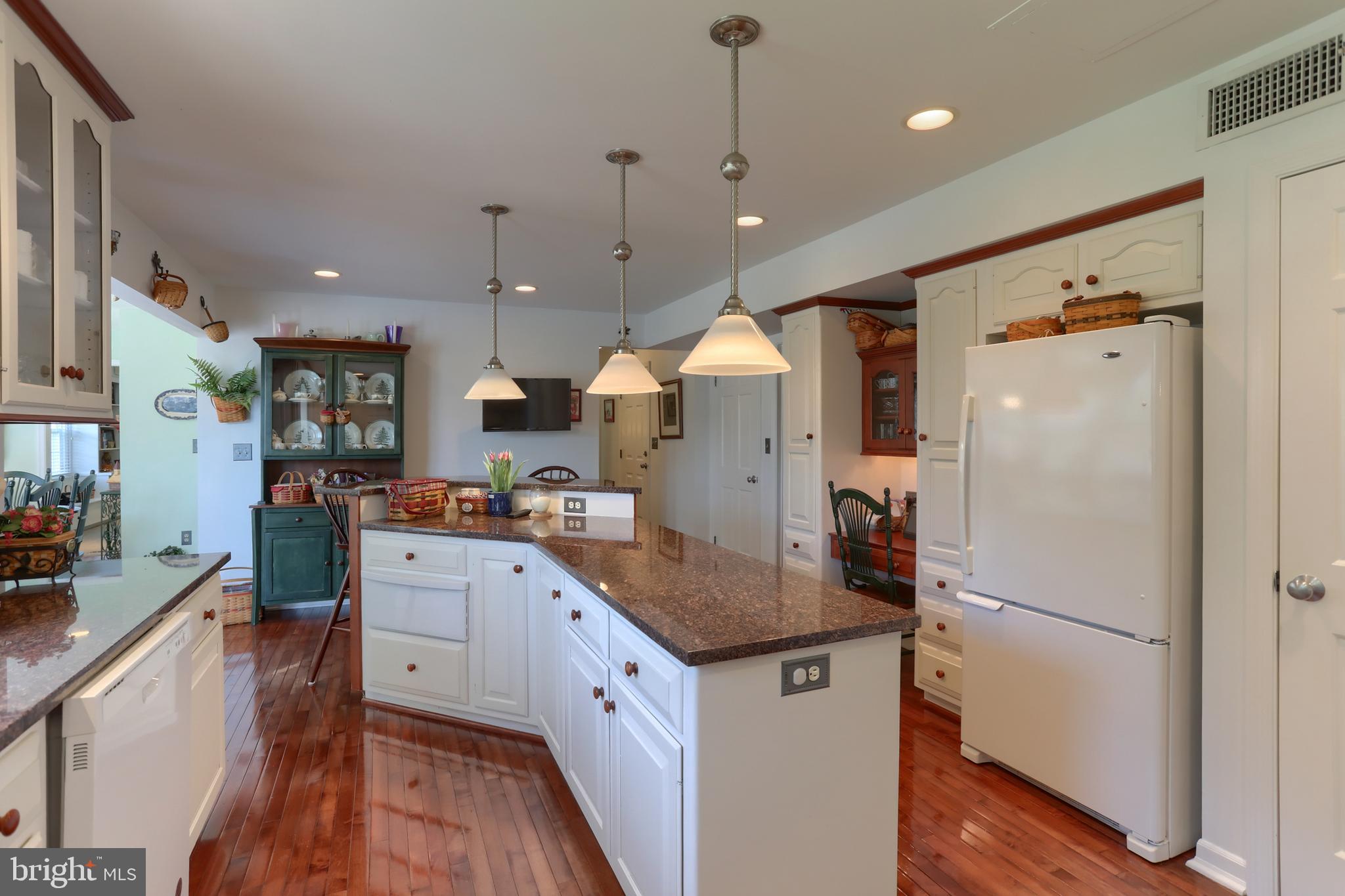 3 Banbury Road Hummelstown, PA 17036 - Photo 22 of 85 a kitchen with granite countertop a refrigerator a sink dishwasher and white cabinets with wooden floor
