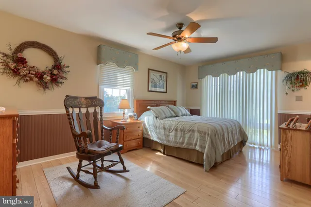 a aerial view of a house next to a big yard and large trees