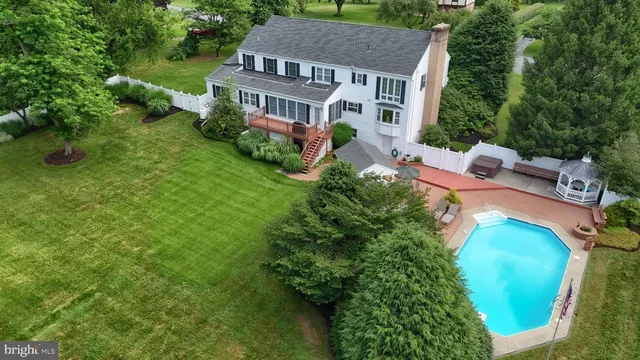 an aerial view of a house with a garden and swimming pool
