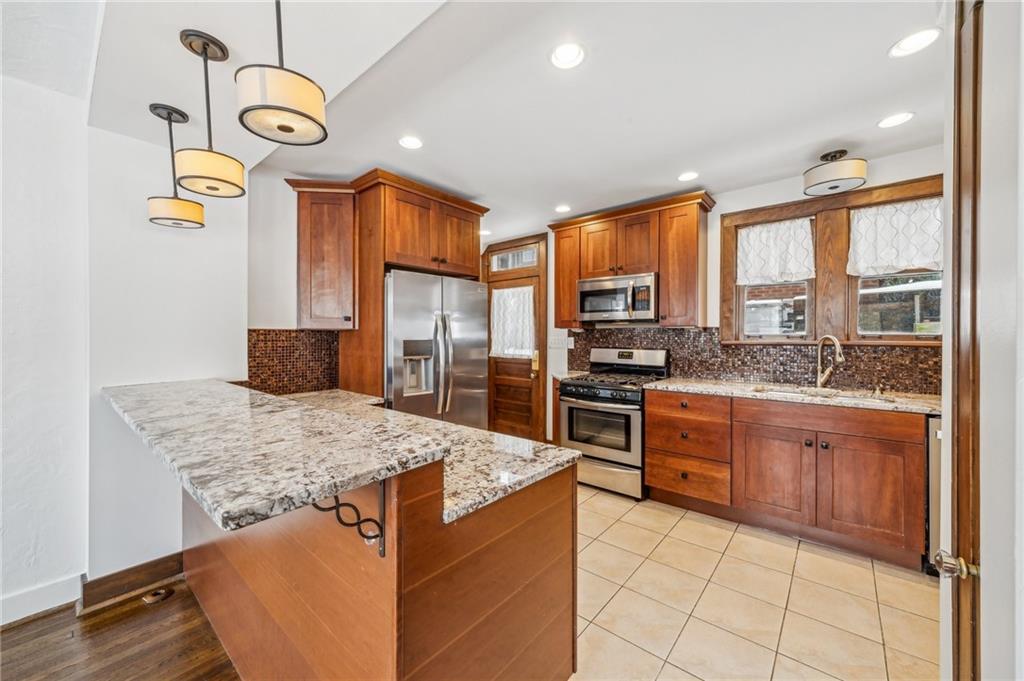 252 Arden Road Pittsburgh, PA 15216 - Photo 8 of 31 Kitchen and dining room are opened up, with granite breakfast bar