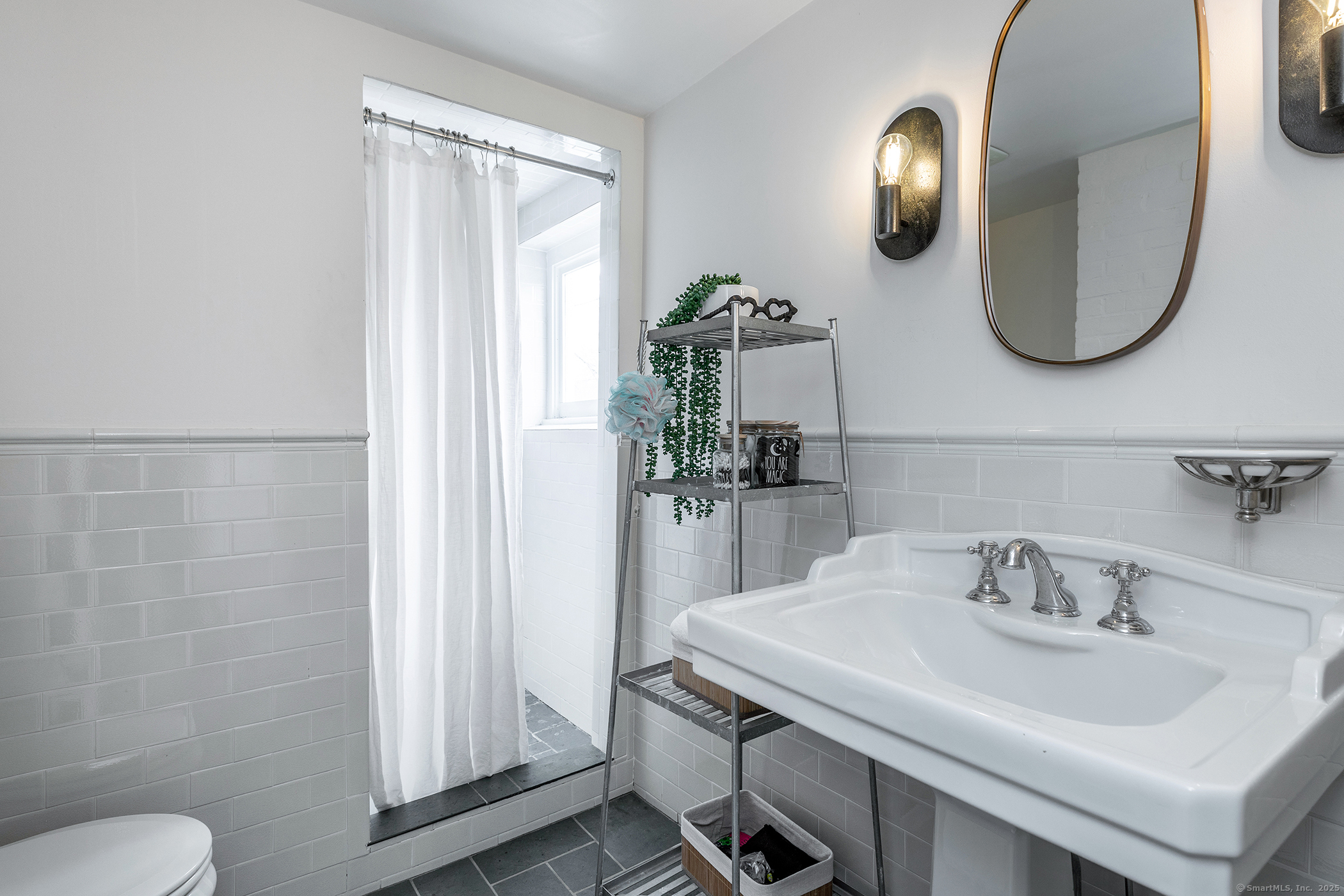 37 South Street Roxbury, CT 06783 - Photo 14 of 20 a bathroom with a sink a toilet and a mirror
