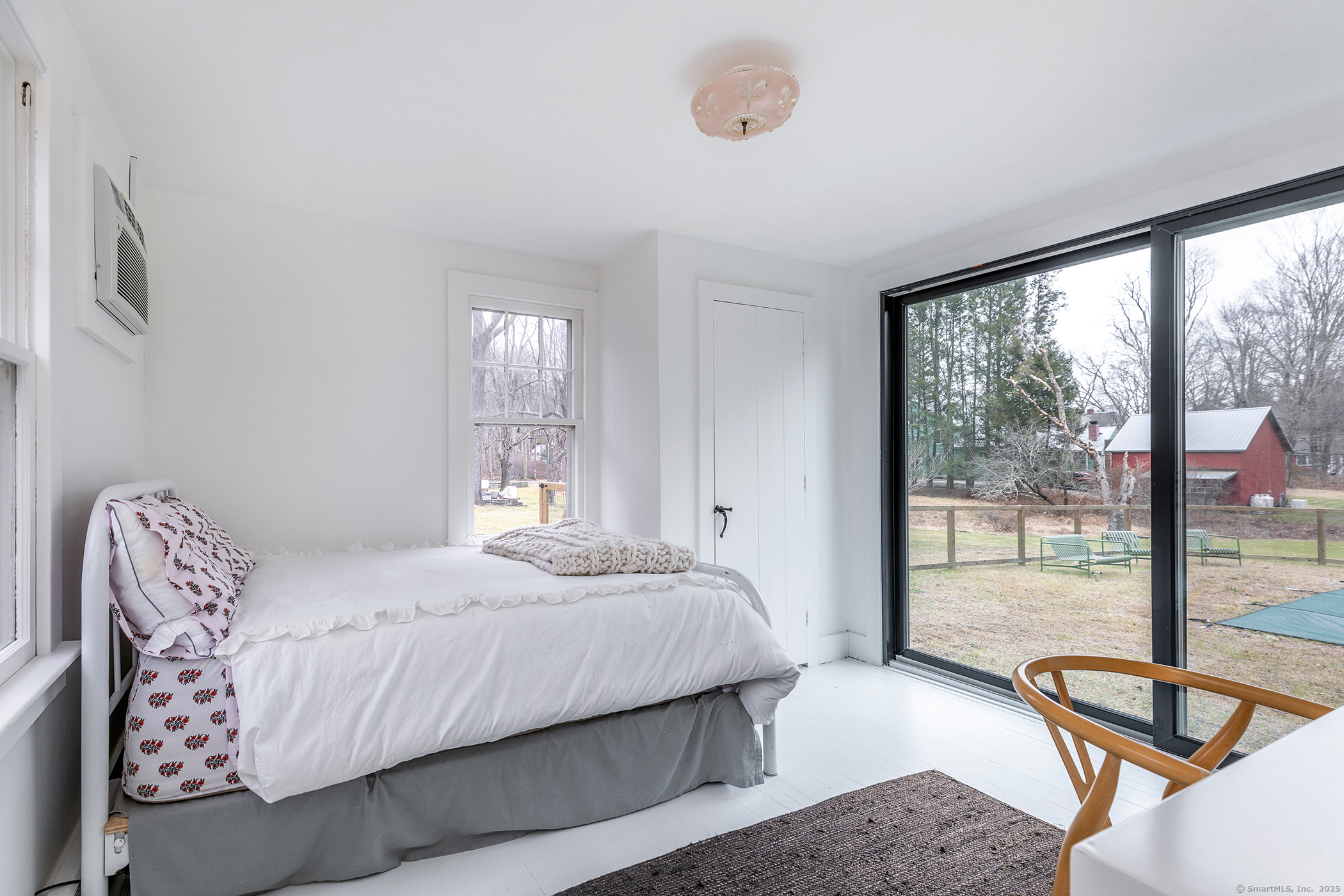 37 South Street Roxbury, CT 06783 - Photo 16 of 20 a bedroom with a bed and glass door