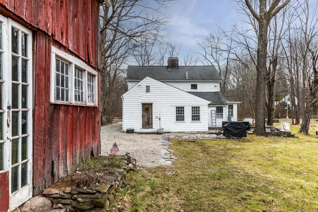 a view of a house with a yard covered in snow