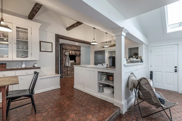 a view of a dining room with furniture and a kitchen