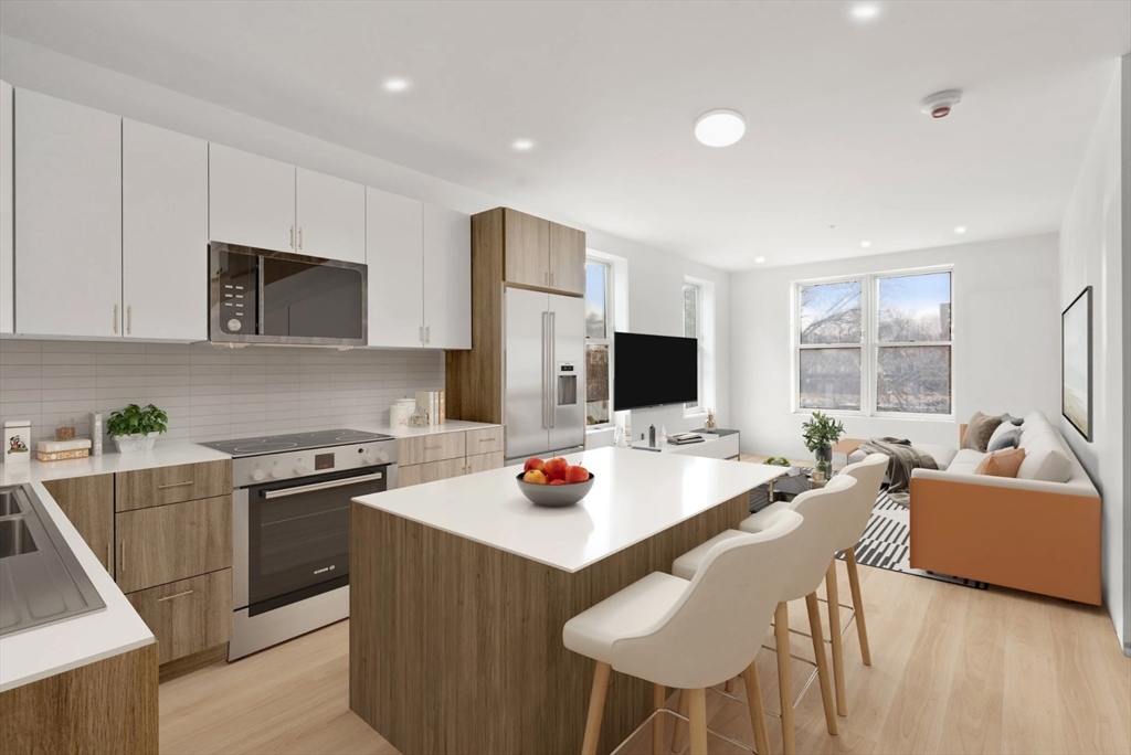 a kitchen with a stove a refrigerator and a dining table