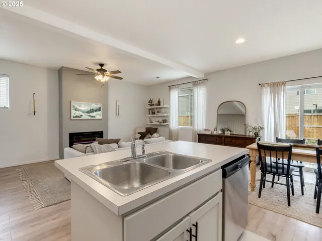 a kitchen with a sink a counter and chairs