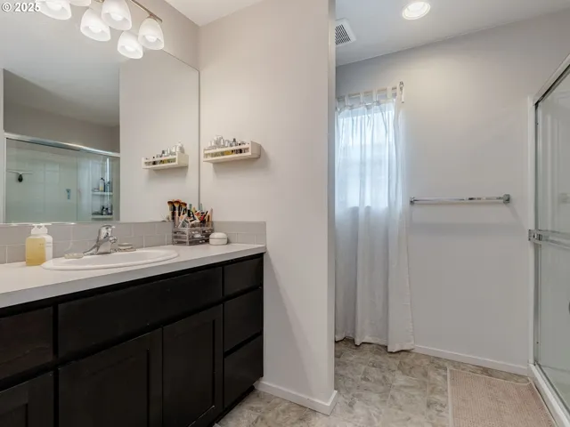 a bathroom with a sink a light fixture and a mirror