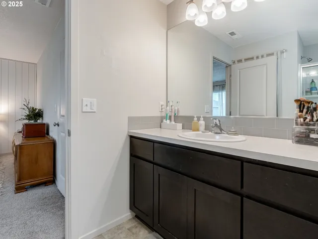 a bathroom with a double vanity sink and a mirror