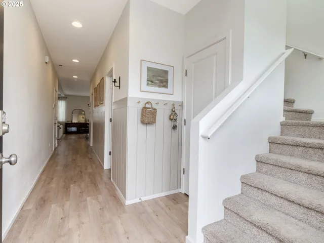 a view of entryway and hall with wooden floor
