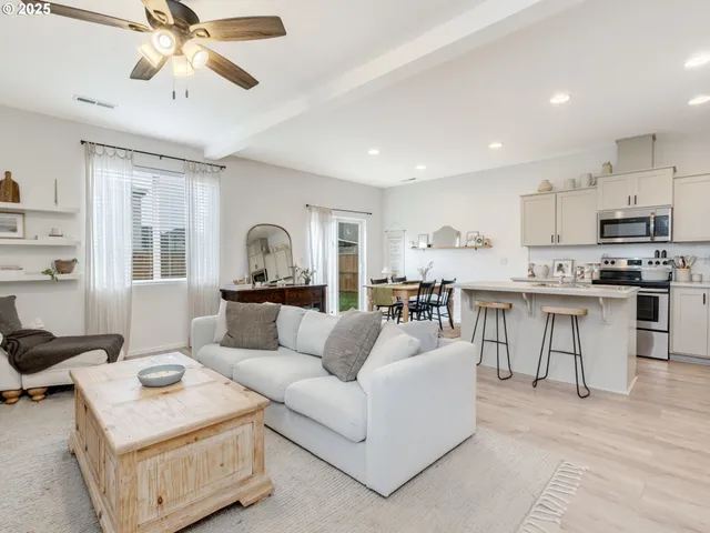 a living room with furniture and kitchen view
