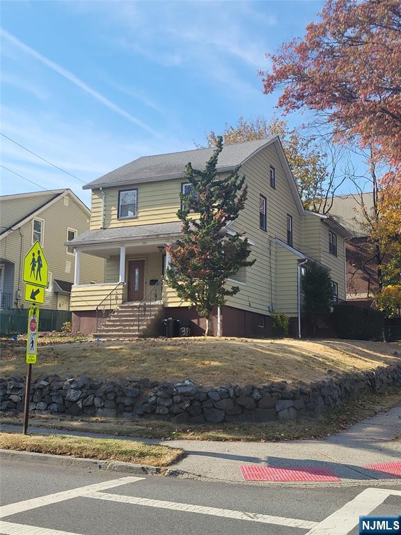 381 Terrace Avenue, Unit 1 Hasbrouck Heights, NJ 07604 - Photo 1 of 3 a front view of a house with a yard