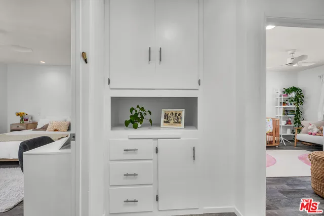 a bedroom with two beds and a potted plant