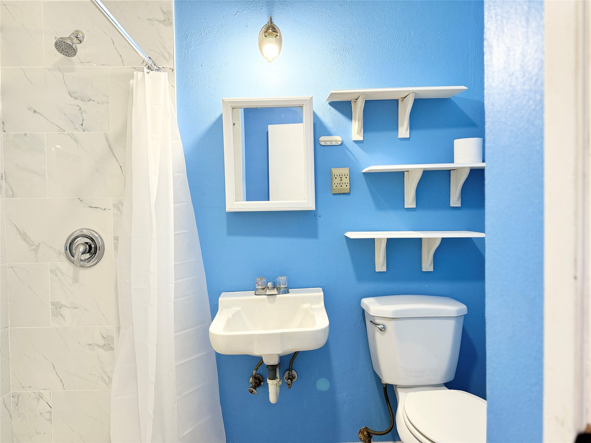 51 Hanging Oak Road Dale, TX 78616 - Photo 28 of 32 Shower with white marble-patterned tile surround and chrome fixtures