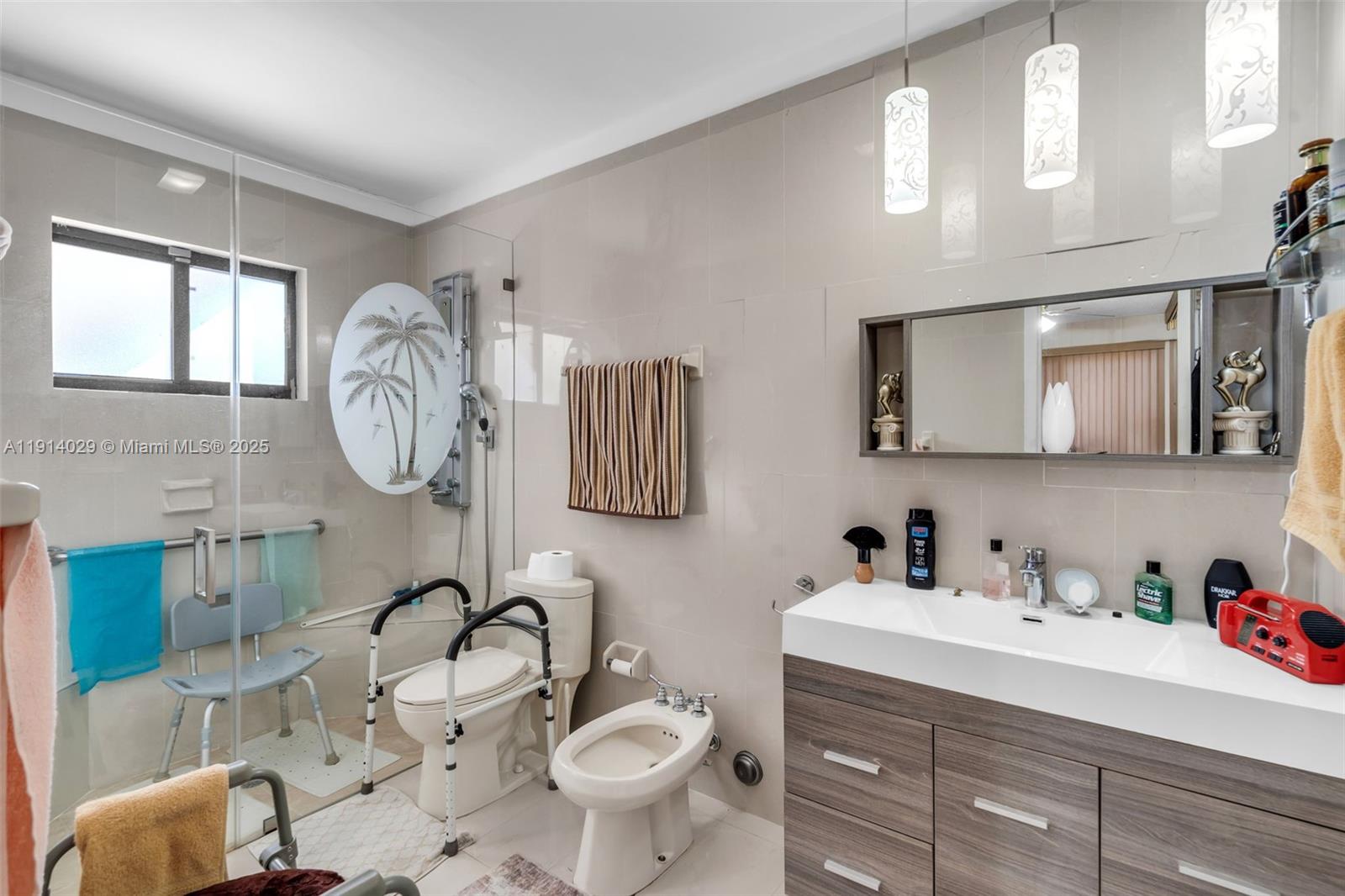 1861 Southwest 19th Street Miami, FL 33145 - Photo 21 of 38 a bathroom with a toilet sink and mirror