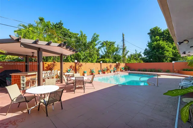 an outdoor sitting area with chairs and table in patio