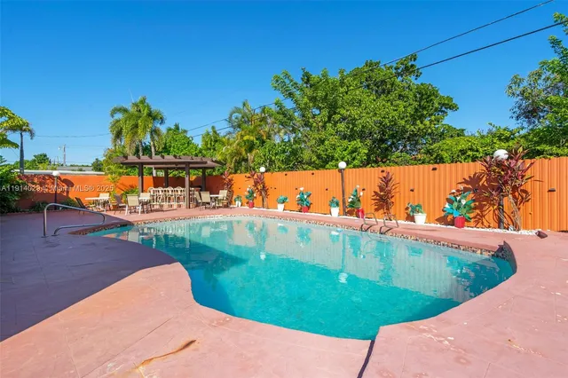 a view of a swimming pool with a yard