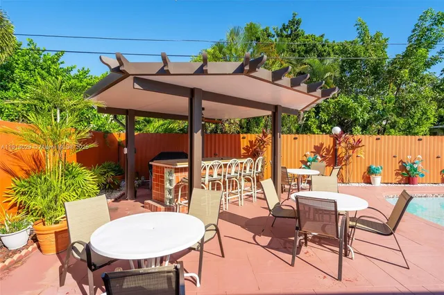 a patio with a table and chairs under an umbrella