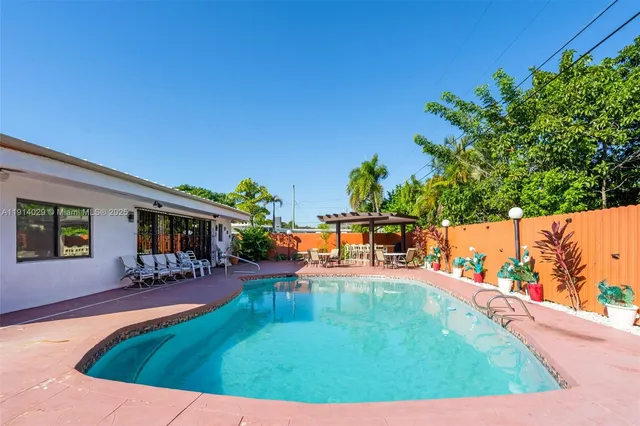 a view of a swimming pool with an outdoor seating