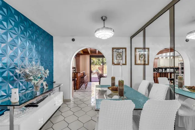 a living room with furniture a fireplace and a chandelier