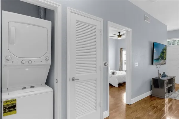 a view of a hallway with workspace and living room