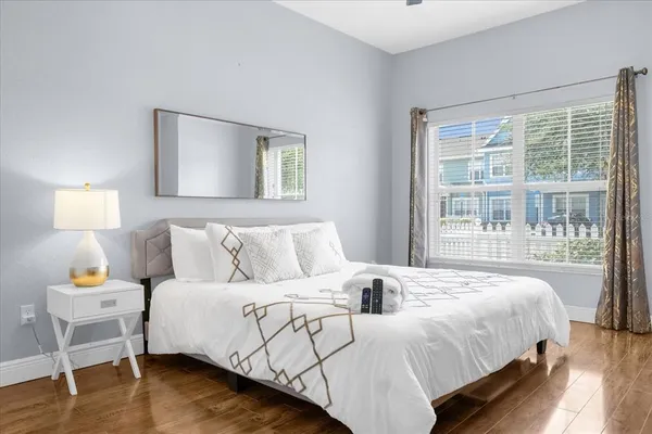 a bedroom with a bed and wooden floor