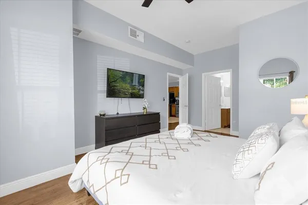 a bedroom with a bed and a flat screen tv