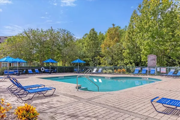 a view of a house with swimming pool and sitting area
