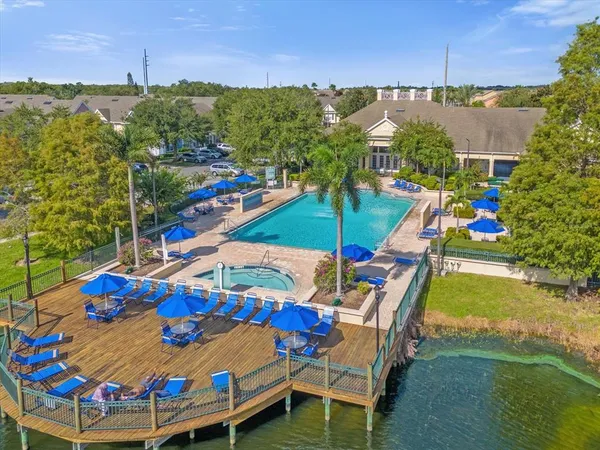 an aerial view of a balcony with chairs and a table