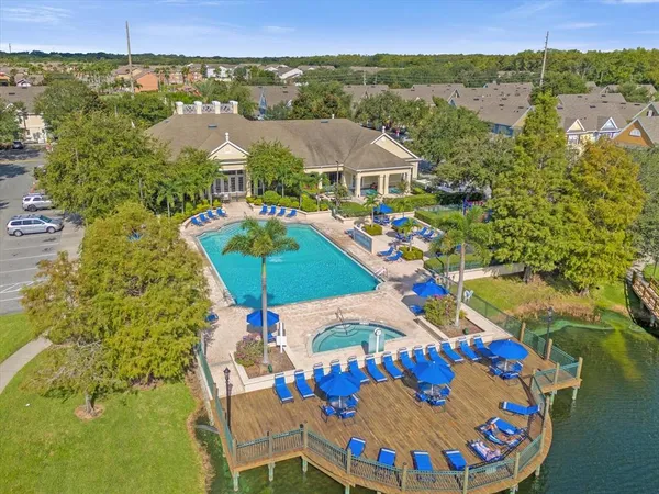 an aerial view of a house with swimming pool garden and patio