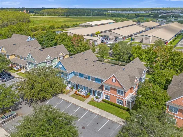 a living room with patio furniture and a dining table