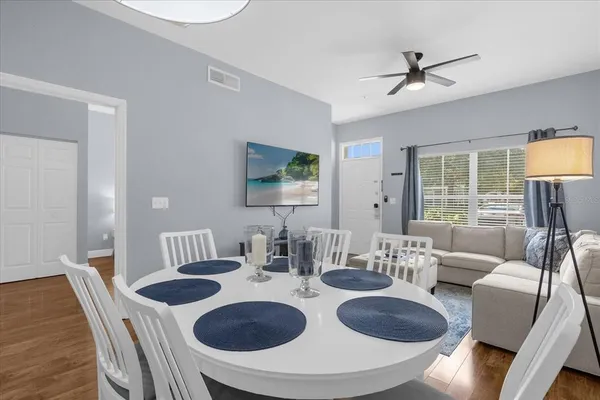 a living room with furniture and a wooden floor