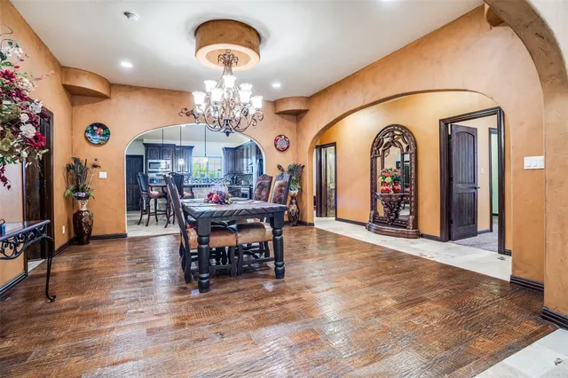 a view of a dining room with furniture and chandelier