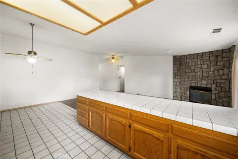 a view of an empty room with a fireplace and a window
