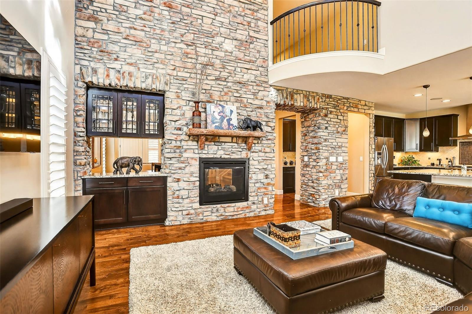 10544 Soulmark Way Highlands Ranch, CO 80126 - Photo 11 of 50 a living room with furniture and a fireplace
