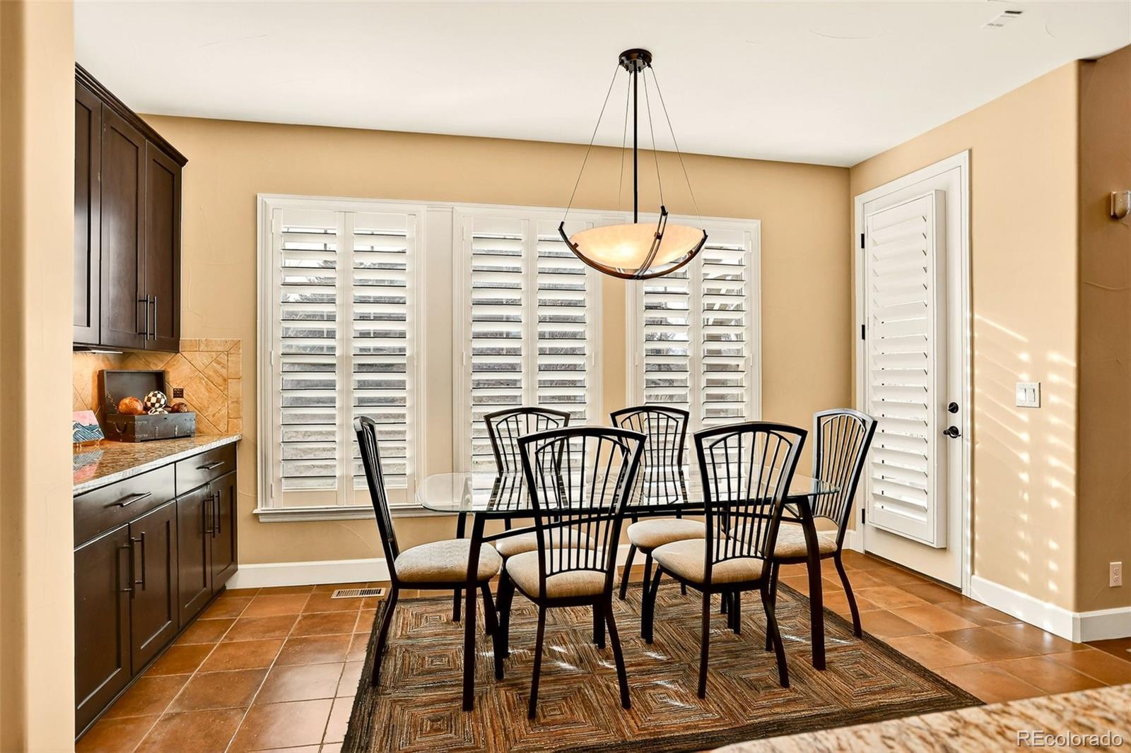 10544 Soulmark Way Highlands Ranch, CO 80126 - Photo 15 of 50 a view of a dining room with furniture window and wooden floor