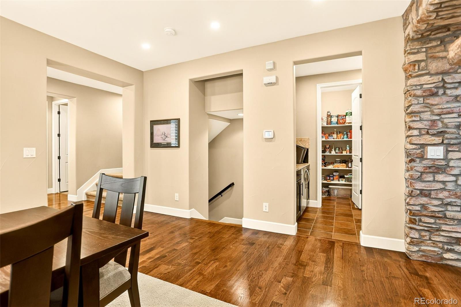 10544 Soulmark Way Highlands Ranch, CO 80126 - Photo 16 of 50 a view of a dining room with furniture and wooden floor